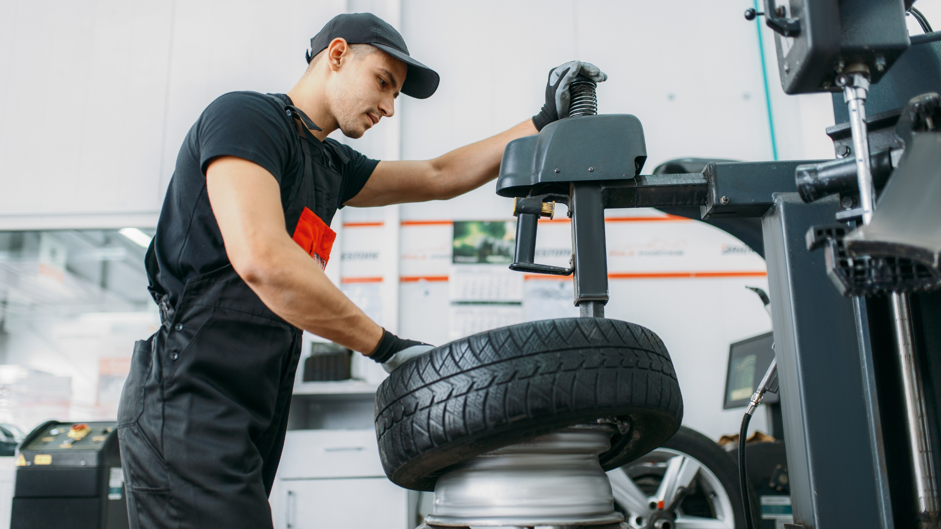 Technician working with tire and wheel service equipment